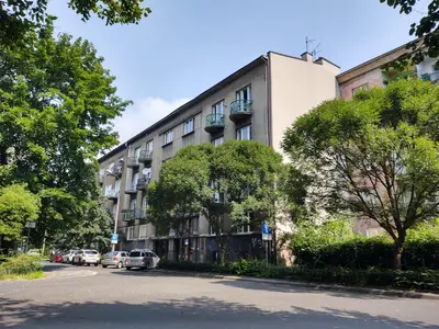 a building with cars parked in front of it at Little Big Red - Central Modern Studio in Kraków