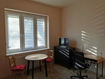 a small room with a desk and a table and chairs at Little Big Red - Central Modern Studio in Kraków