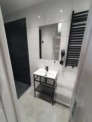 a bathroom with a sink and a mirror at Mirror Apartments in Oświęcim