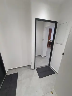 a hallway with a mirror in a white room at Mirror Apartments in Oświęcim