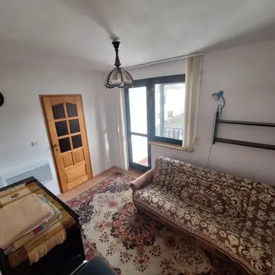 a bedroom with a bed and a dresser and a rug at Domek Zawoja in Zawoja