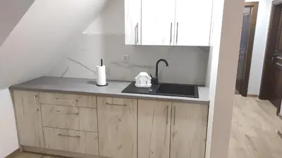 a kitchen with a sink and a counter top at Gospodarstwo agroturystyczne U Kierpców. in Podwilk
