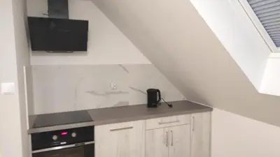 a kitchen with a sink and a stove at Gospodarstwo agroturystyczne U Kierpców. in Podwilk