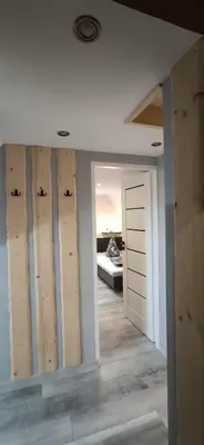 a room with a wall with wood panels on it at Pokoje Gościnne Tyrol in Zawoja