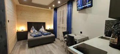 a room with a bed and a table in a room at Pokoje Gościnne Tyrol in Zawoja