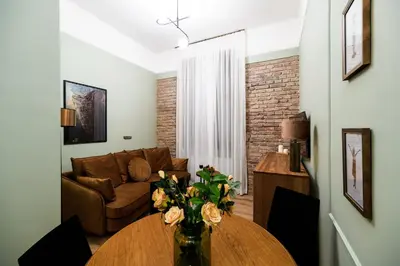 a living room with a table and a couch at Apart Residence Ariańska 16 by NEARTO PL in Kraków