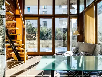 a glass table and chairs in a room with windows at Zwierzyniecka Lofts with Patio and Air Conditioning, Cracow city heart Old Town in Kraków