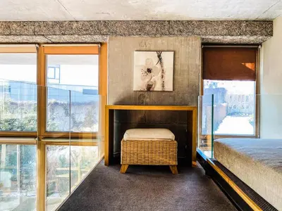 a bedroom with a bed and large windows at Zwierzyniecka Lofts with Patio and Air Conditioning, Cracow city heart Old Town in Kraków