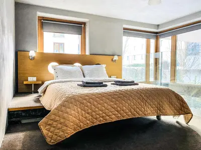 a bedroom with a large bed with a large window at Zwierzyniecka Lofts with Patio and Air Conditioning, Cracow city heart Old Town in Kraków