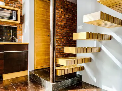 a spiral staircase in a kitchen with a brick wall at Zwierzyniecka Lofts with Patio and Air Conditioning, Cracow city heart Old Town in Kraków