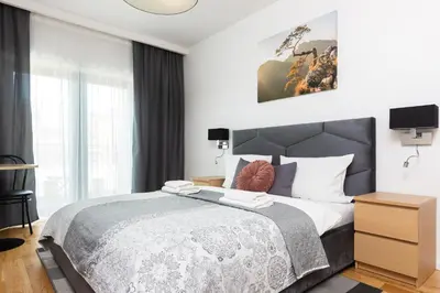 a bedroom with a large bed and a window at Old Town Rajska street in Kraków