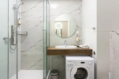 a bathroom with a sink and a washing machine at Old Town Rajska street in Kraków