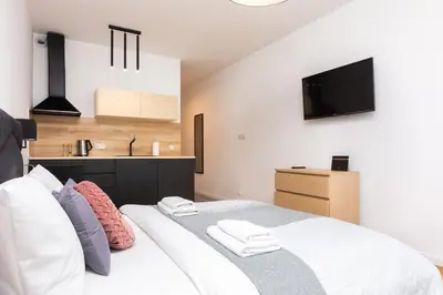 a bedroom with a large bed with two towels at Old Town Rajska street in Kraków