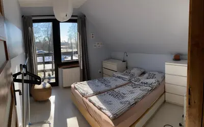 a small bedroom with a bed and a window at Chata na Łąkach in Jerzmanowice