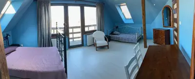 a blue bedroom with two beds and a window at Chata na Łąkach in Jerzmanowice