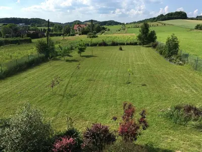 a large field of green grass with a fence at Chata na Łąkach in Jerzmanowice