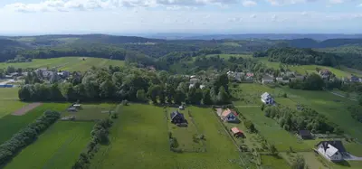 an aerial view of a small village in a green field at Chata na Łąkach in Jerzmanowice