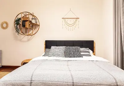 a bedroom with a bed and a chandelier at Mateyko Boho in Kraków