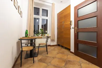a room with a table and chairs and a door at Mateyko Boho in Kraków