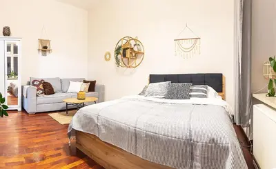 a bedroom with a bed and a couch at Mateyko Boho in Kraków