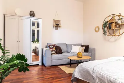 a living room with a couch and a table at Mateyko Boho in Kraków