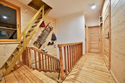 a bedroom with two beds in a room with wooden walls at Willa Dalia in Rabka