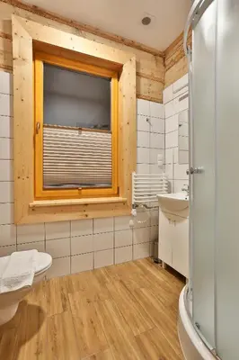 a white bathroom with a sink and a toilet at Willa Dalia in Rabka