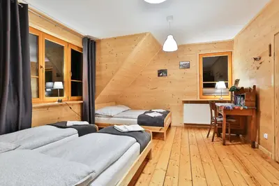 a kitchen with a sink and a wooden floor at Willa Dalia in Rabka