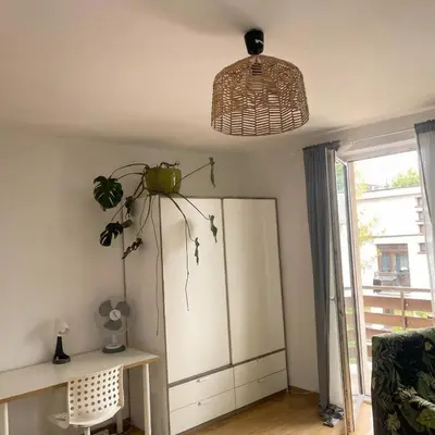 a living room with a plant on the ceiling at Beautiful apartment with balcony in Kraków