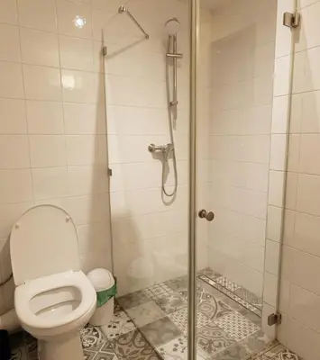 a bathroom with a toilet and a shower at Beautiful apartment with balcony in Kraków