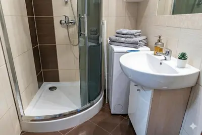 a bathroom with a shower and a sink and a toilet at Cracow nest - 2 separate rooms, heart of Kazimierz in Kraków