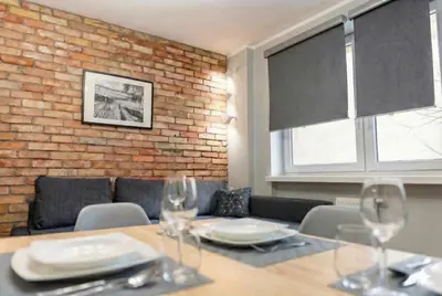 a dining room with a table with wine glasses at Cracow nest - 2 separate rooms, heart of Kazimierz in Kraków