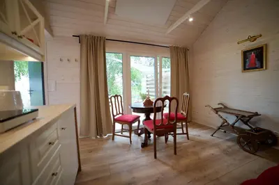 a kitchen with a table and chairs in a room at JURA GLAMP luksusowe całoroczne domki na wyłączność KOPUŁY IGLOO taras ogród in Wola Kalinowska