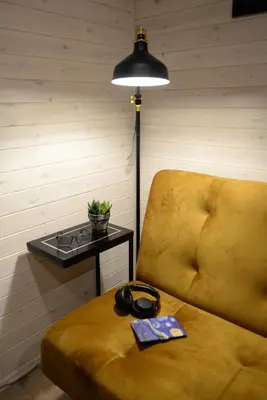 a room with a yellow couch and a table with a lamp at JURA GLAMP luksusowe całoroczne domki na wyłączność KOPUŁY IGLOO taras ogród in Wola Kalinowska