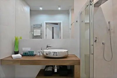 a bathroom with a sink and a shower at Apartamenty Prestige Browar Lubicz Stare Miasto in Kraków