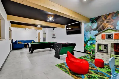 a pool table in a room with a mural at Zdrojowy Gościniec - domki Rabka-Zdrój in Rabka