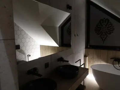 a bathroom with a sink and a mirror at Domki PRemium in Zawoja