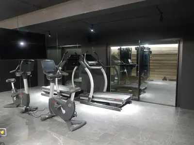 a gym with several exercise equipment in a room at Domki PRemium in Zawoja