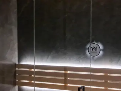 an apple sign hanging from a wall in a room at Domki PRemium in Zawoja