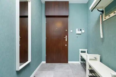 a hospital hallway with a wooden door and a sink at Premium Apartment Ludwinowska Kraków by Noclegi Renters in Kraków