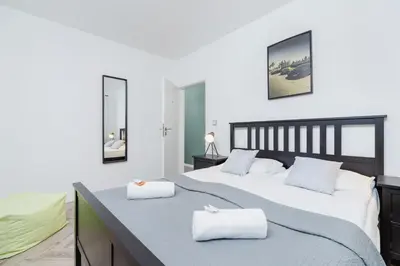a bedroom with a large bed with two white pillows at Premium Apartment Ludwinowska Kraków by Noclegi Renters in Kraków