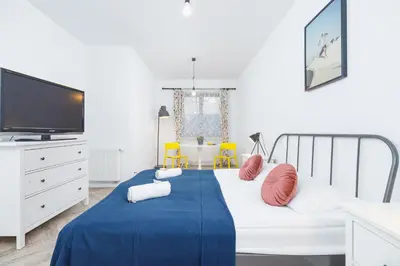 a bedroom with a bed with a blue blanket at Premium Apartment Ludwinowska Kraków by Noclegi Renters in Kraków