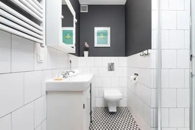 a white bathroom with a sink and a toilet at Premium Apartment Ludwinowska Kraków by Noclegi Renters in Kraków