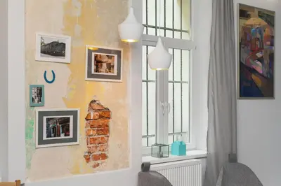 a room with a window and a wall with pictures at Quiet & Comfortable Old Krakow Apartment in Kraków