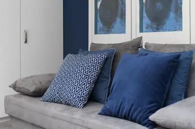 a couch with pillows on it in a living room at Quiet & Comfortable Old Krakow Apartment in Kraków