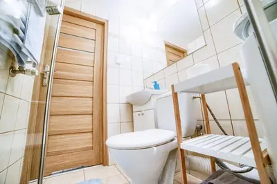 a small bathroom with a toilet and a shower at Quiet & Comfortable Old Krakow Apartment in Kraków