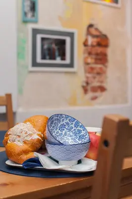 a plate with bread and a bowl on a table at Quiet & Comfortable Old Krakow Apartment in Kraków