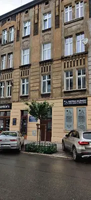 two cars parked in front of a building at Quiet & Comfortable Old Krakow Apartment in Kraków