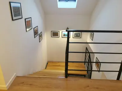 a stairwell with pictures on the wall at Hygge House in Zator