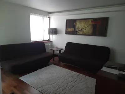 a living room with a couch and a table at APARTAMENT LUCYNA in Rabka